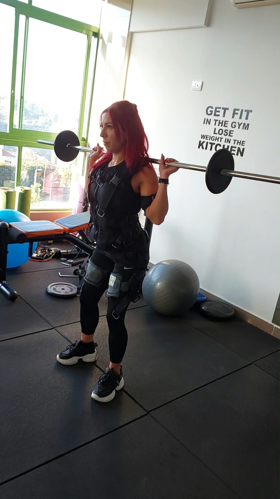 A client training with a barbell in the Fitfinity studio